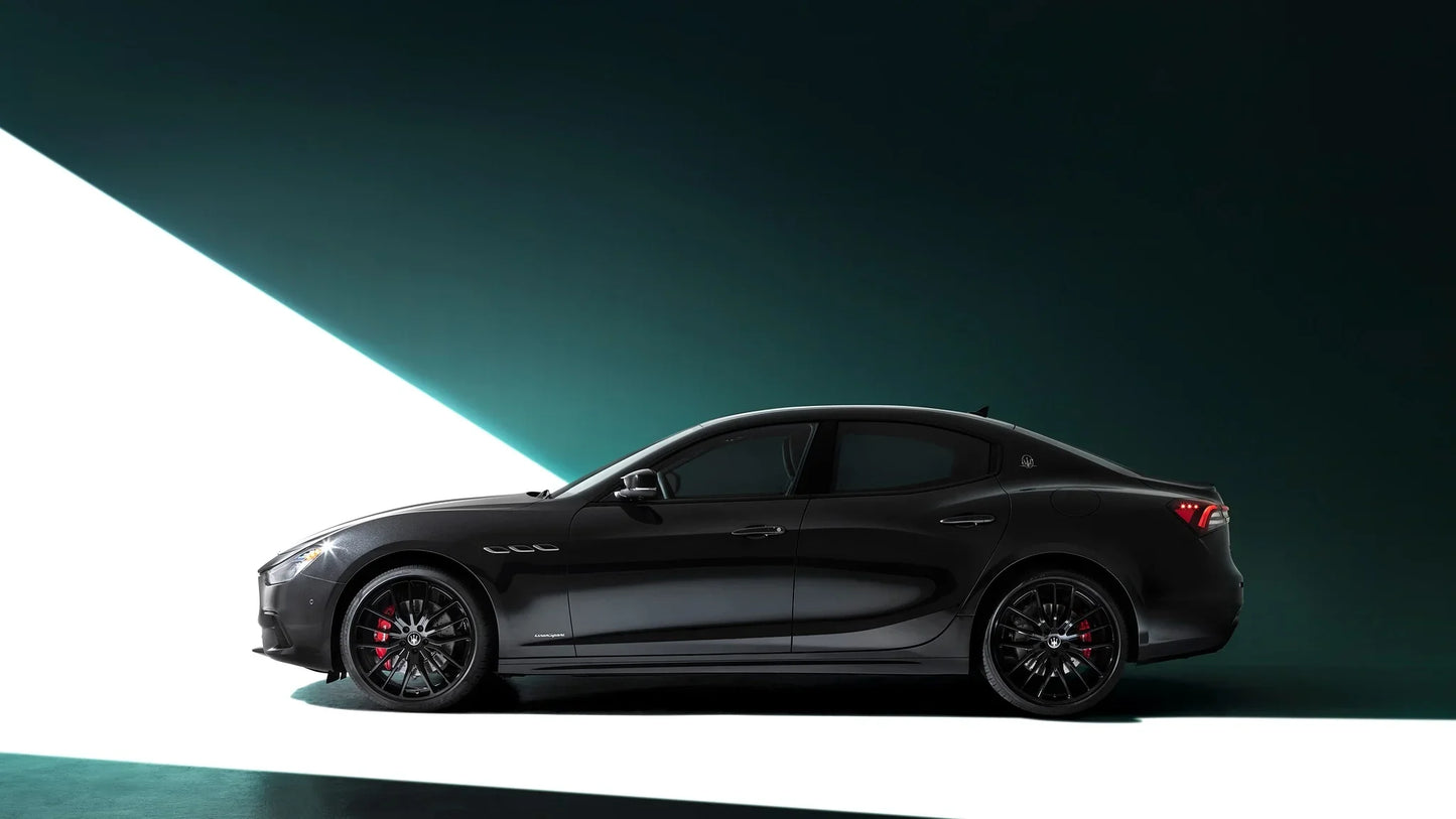 Black 2021 Maserati Ghibli S Q4 GranSport Nerissimo side view in studio with dramatic lighting