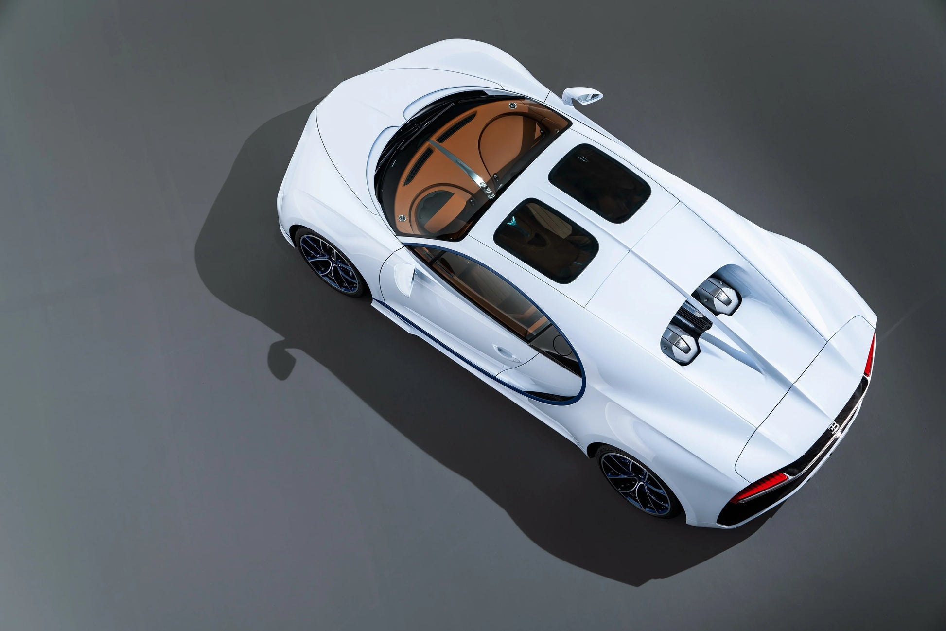 White Bugatti Chiron supercar top-down view showing sleek design and twin engine covers