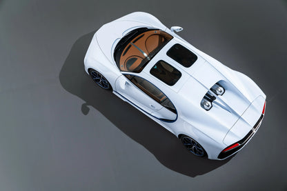 White Bugatti Chiron supercar top-down view showing sleek design and twin engine covers