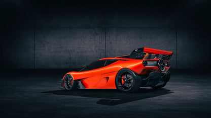 Sleek red Gordon Murray Automotive T.50s Niki Lauda supercar in dark industrial setting