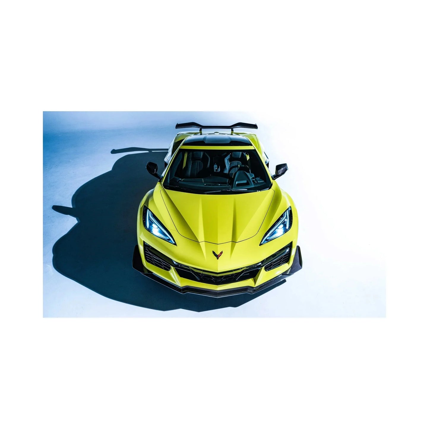 Bright yellow stunt Corvette sportscar front view with aggressive design on white background
