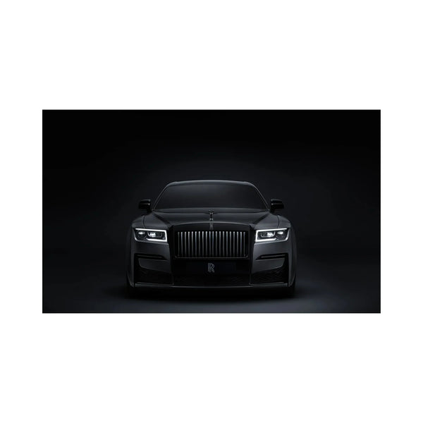 Front view of a sleek black Rolls-Royce luxury car with illuminated headlights against a dark background
