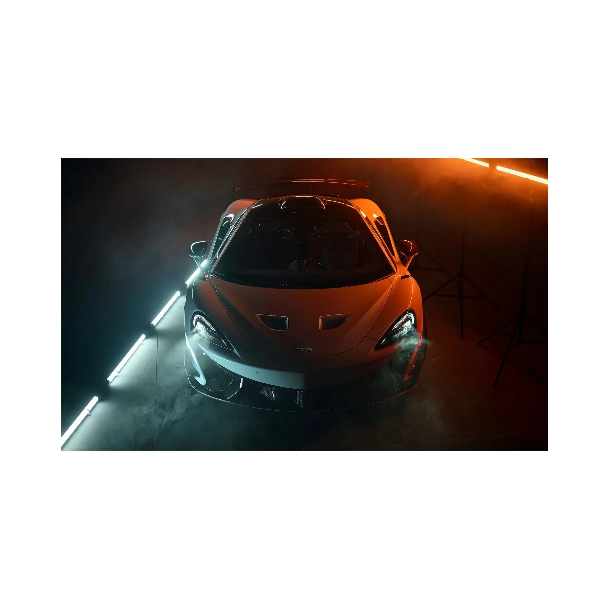 Front view of a sleek sports car in a smoke-filled studio with blue and orange LED lighting