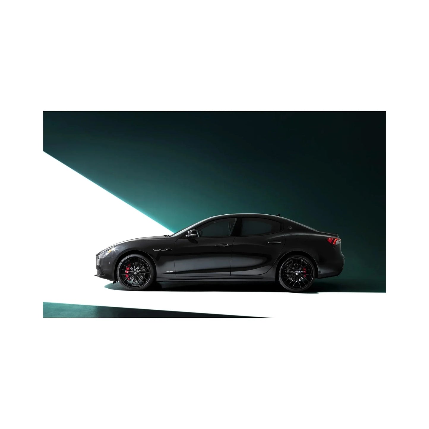 Sleek black luxury sports sedan with red brake calipers on black wheels, modern light backdrop