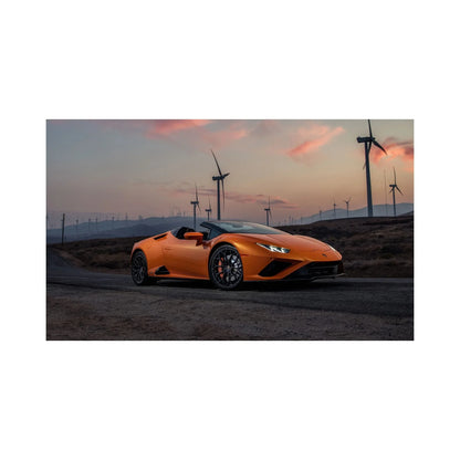 Orange Lamborghini Huracan Spyder on rural road at sunset with wind turbines in the background