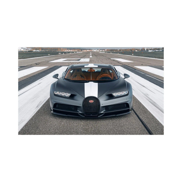 Front view of black Bugatti Chiron with white racing stripe parked on runway