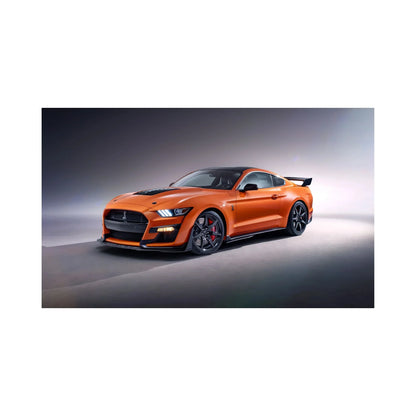 Orange Ford Mustang Shelby GT500 sports car with black accents in studio lighting