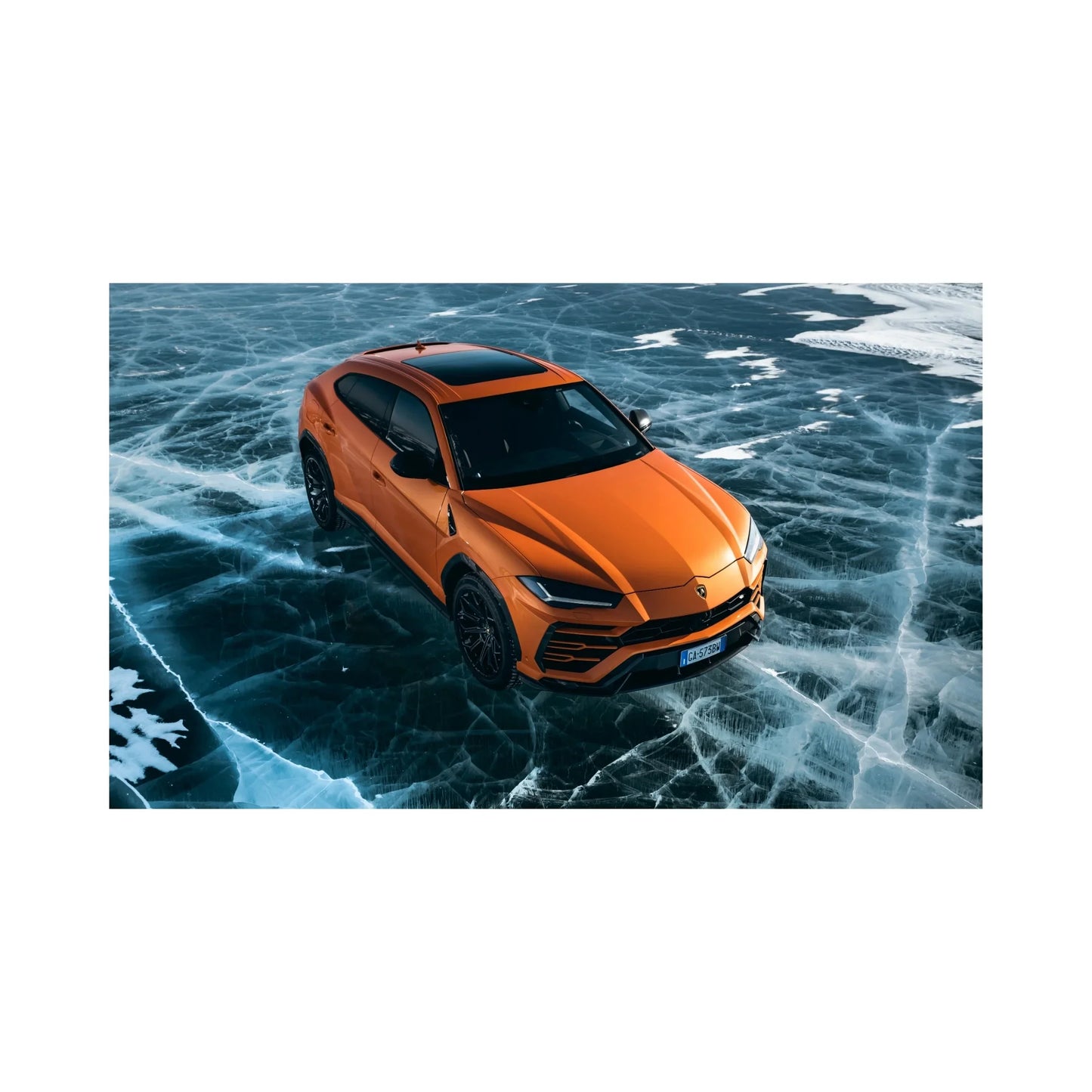 Orange Lamborghini Urus SUV parked on cracked icy frozen lake surface with snow patches