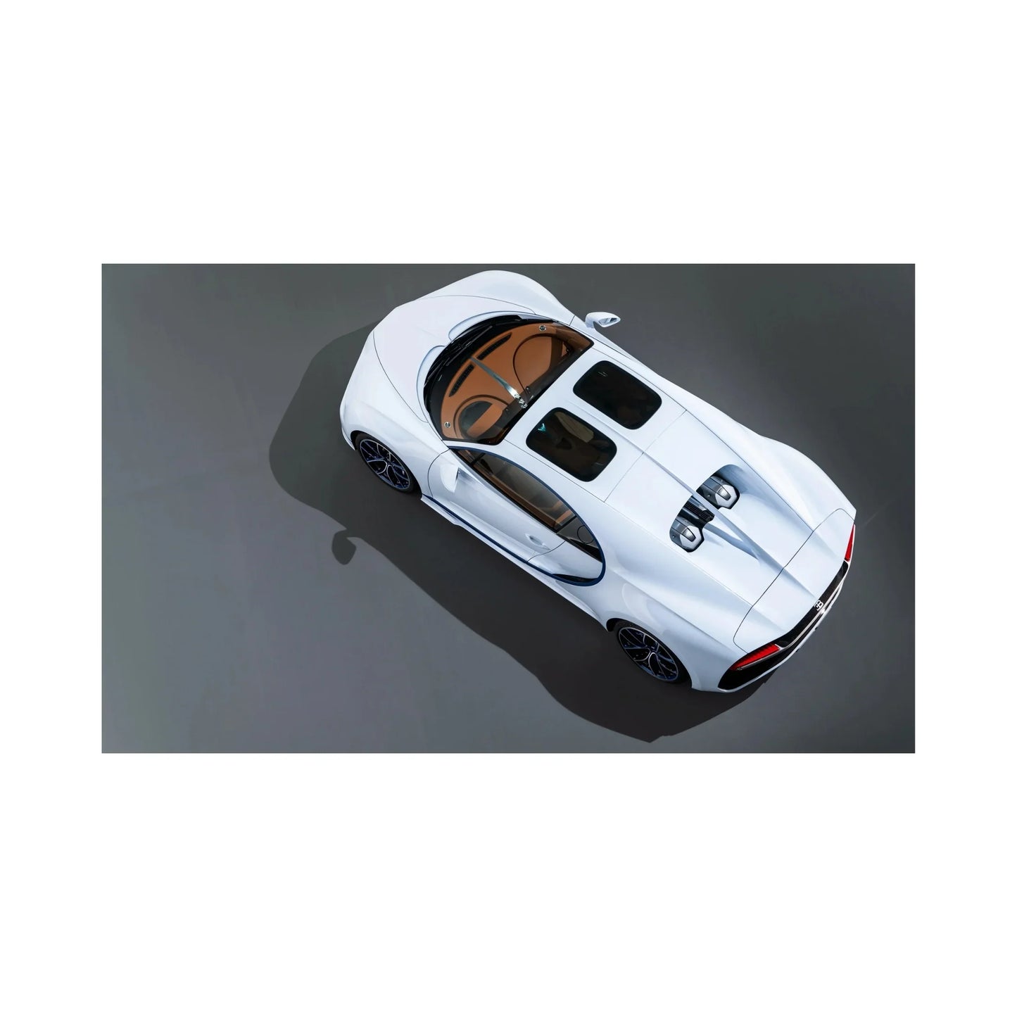 Top view of a white luxury sports car with tan leather interior and sleek aerodynamic design