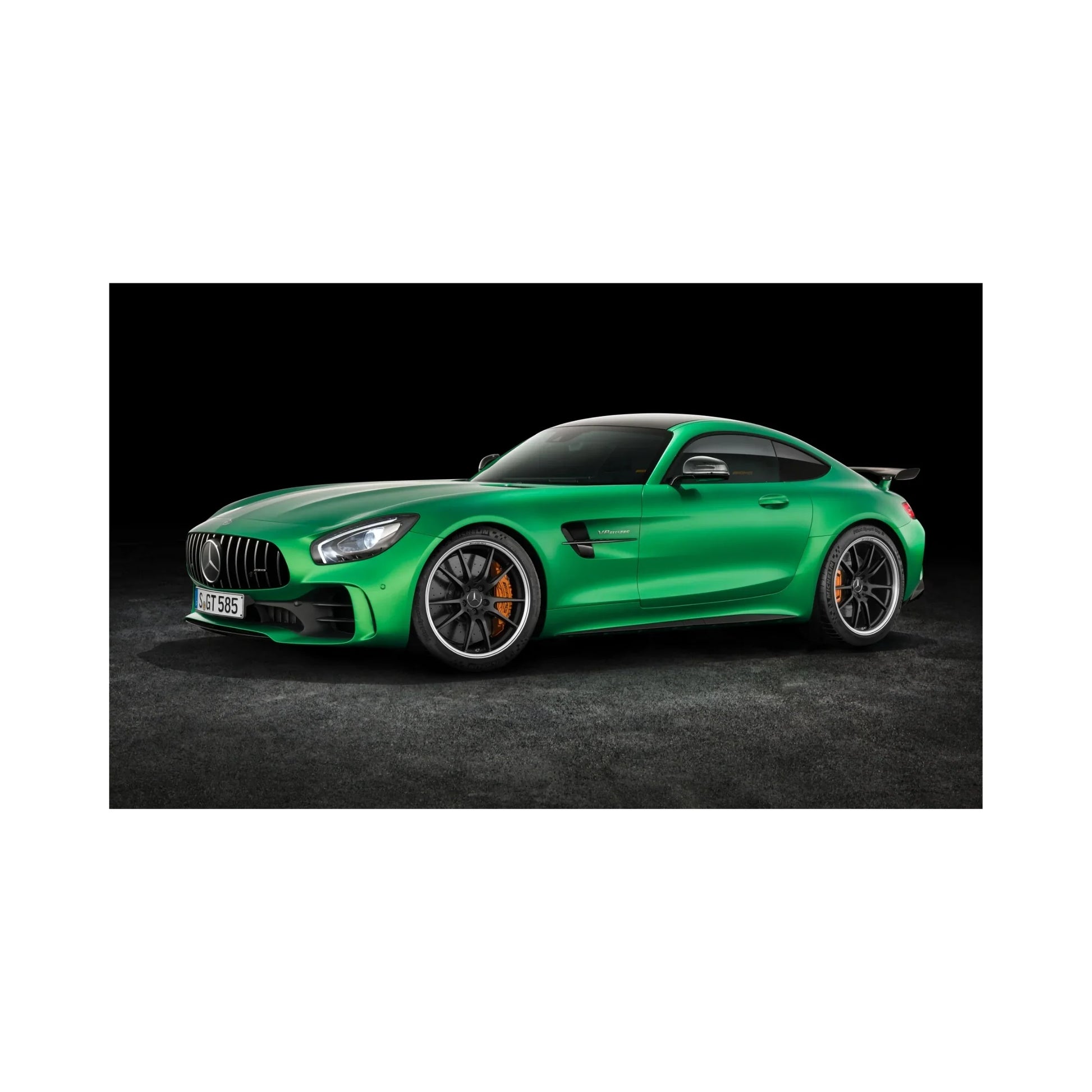 Green Mercedes-AMG GT sports car with black rims and orange brake calipers on dark background