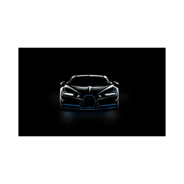 Front view of a sleek black luxury sports car with illuminated headlights on black background